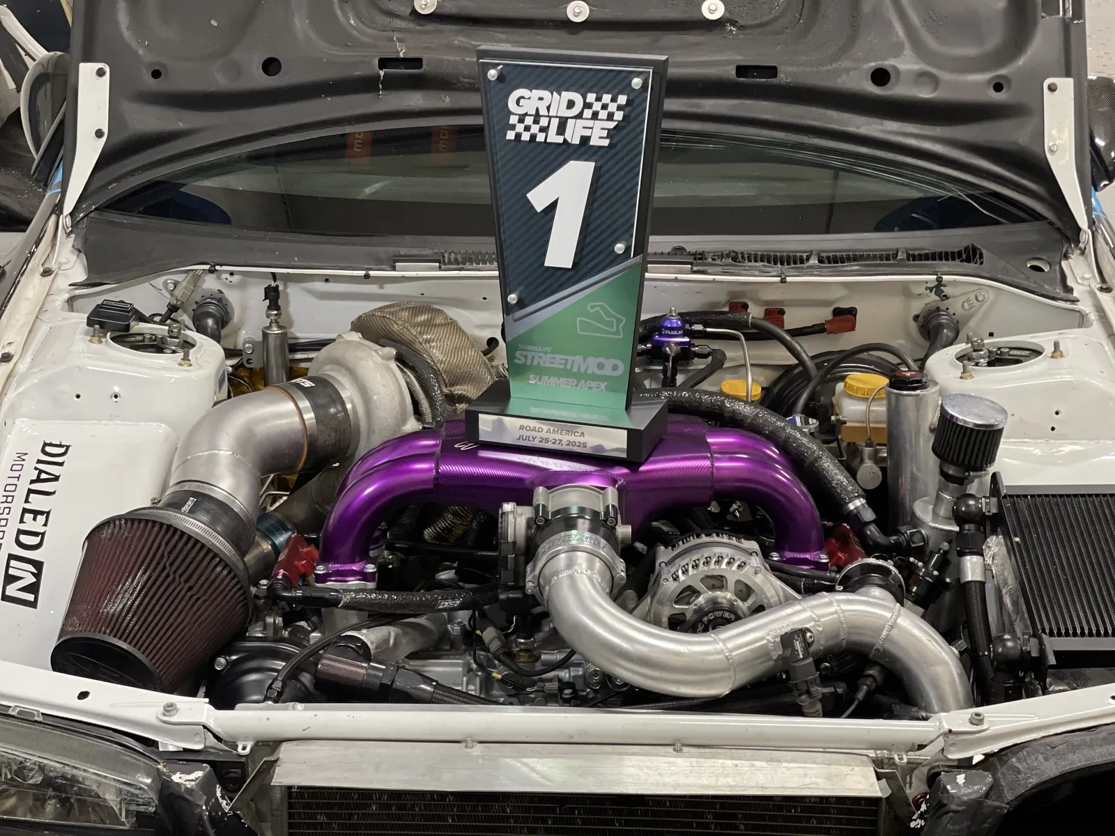 Team Boogeyman #70 engine bay with Grid Life #1 championship trophy — IAG Performance build